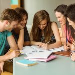 36411247 — smiling friends sitting studying together after school